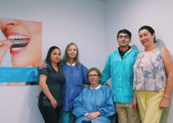 A group of people in scrubs and masks posing for the camera.